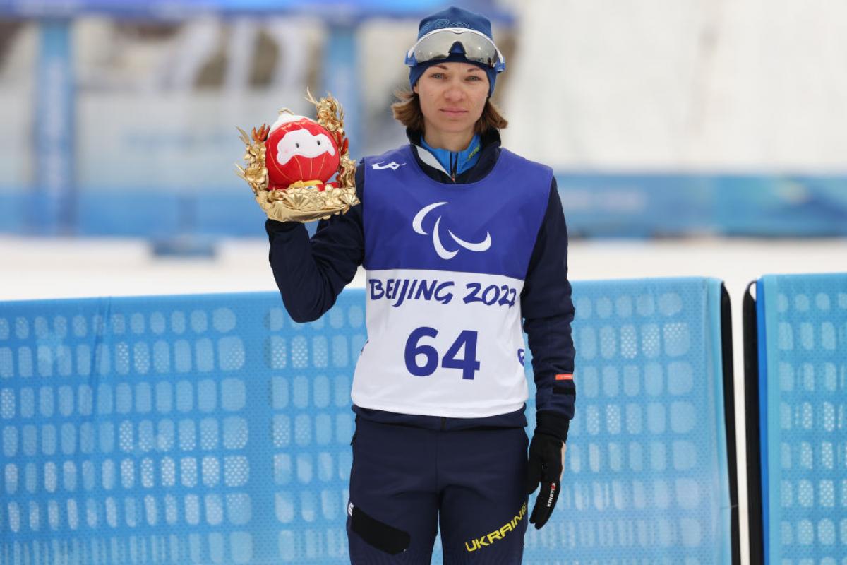 Liudmyla Liashenko of Ukraine poses after winning the Para Biathlon Women's Individual Standing at the Beijing 2022 Winter Paralympics.